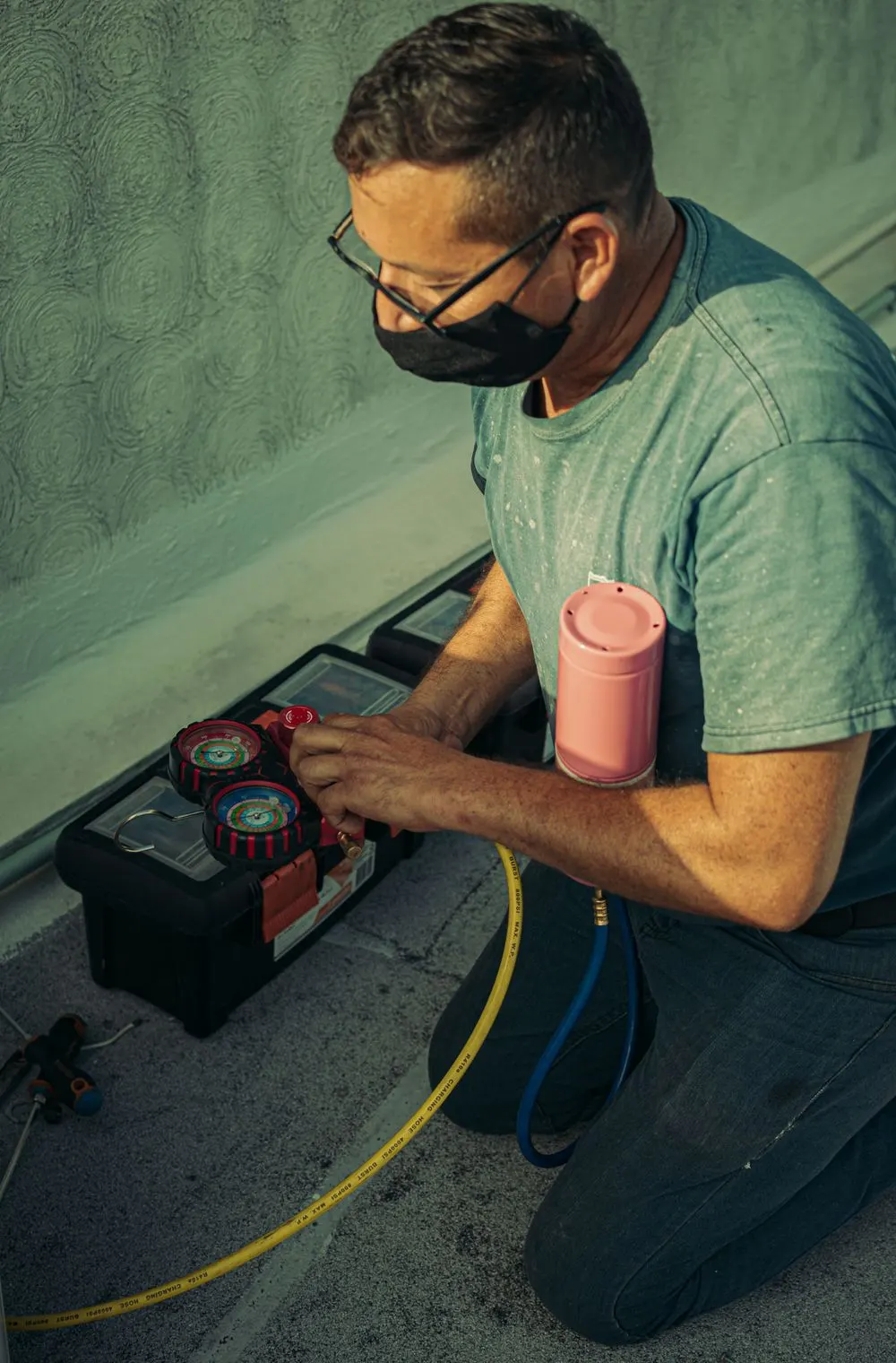 Stock photo of an HVAC technician checking gauges — illustrative energy audit equipment review